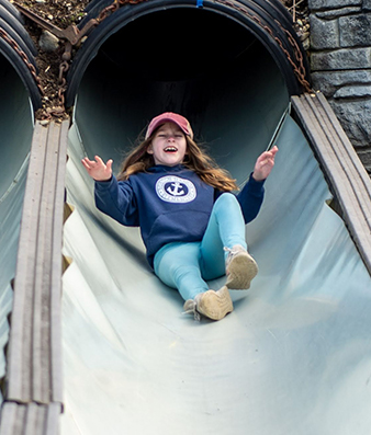 Girl Slides Down Tube Slide